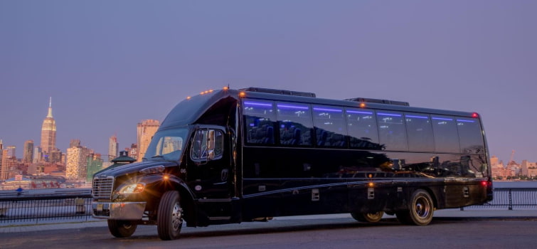A luxury minibus employee shuttle parks in view of the New York City skyline