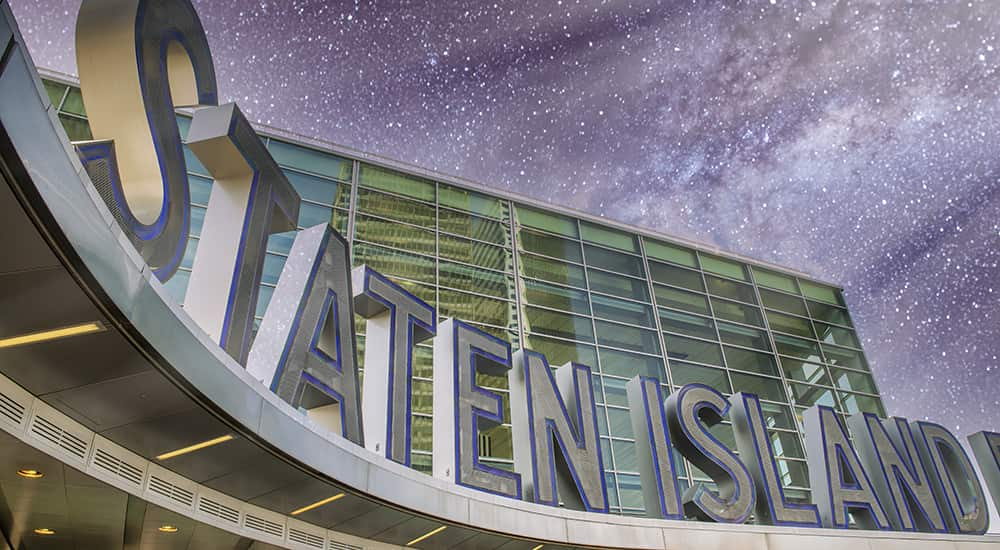 A large sign reads 'Staten Island' under the night sky